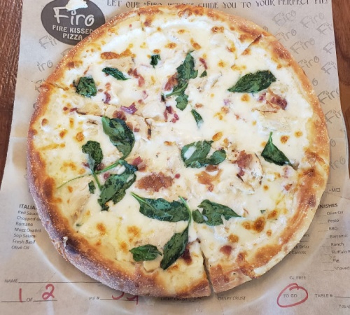 Chicken Alfredo pizza ($8.25) includes Alfredo sauce, artisan cheeses, spinach, grilled chicken and applewood bacon.