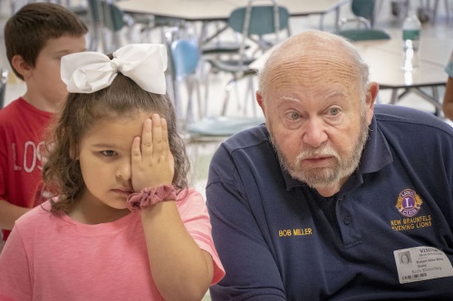 New Braunfels Lions Club member Bob Miller administers a vision screening for a Seele Elementary School student Oct. 4.