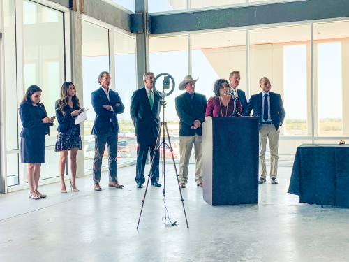 Diana Torres, Kyle's director of economic development, stands with Mayor Travis Mitchell, Hays County Commissioner Mark Jones and others at the SmileDirectClub announcement ceremony Oct. 8.