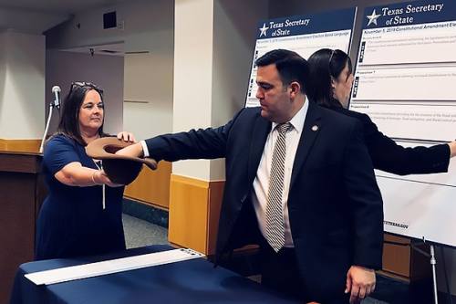 Deputy Secretary Esparza selects the ballot ordernby drawing propositions out of a hat.